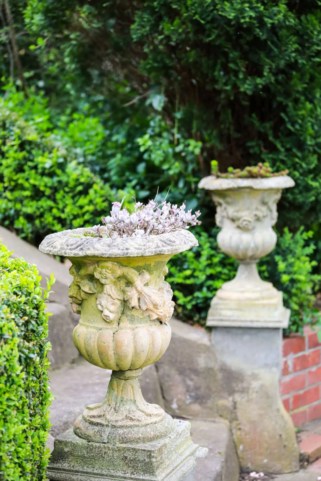 Garden detail with stone urn planter at ProLodge Ballintrae